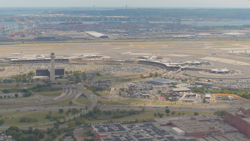 Straßenschild zum Newark Liberty International Airport vor dem Kontrollturm des Flughafens