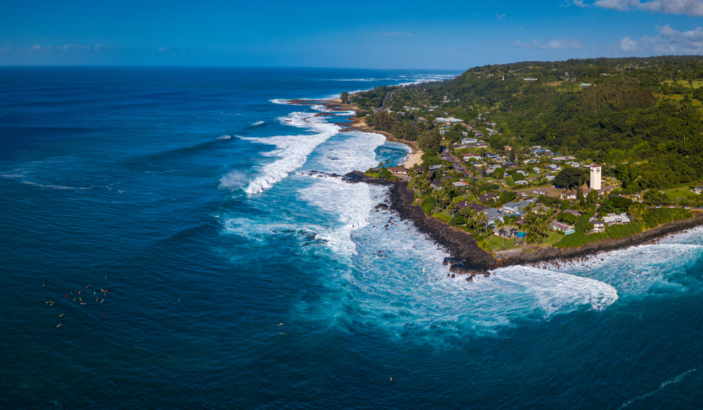 Luftaufnahme der North Shore auf Oahu mit Surfern an der Waimea Bay
